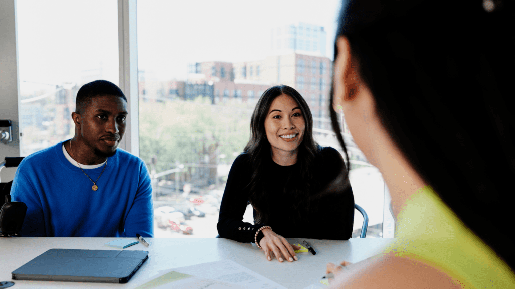 Three colleagues collaborating in a meeting together