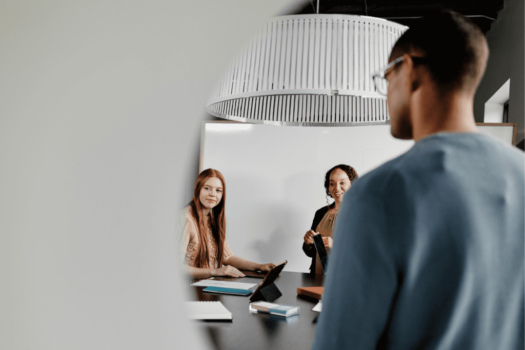 Colleagues work on a project in a conference room.