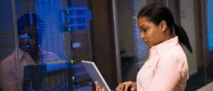 Software Engineer works on their laptop in the server room